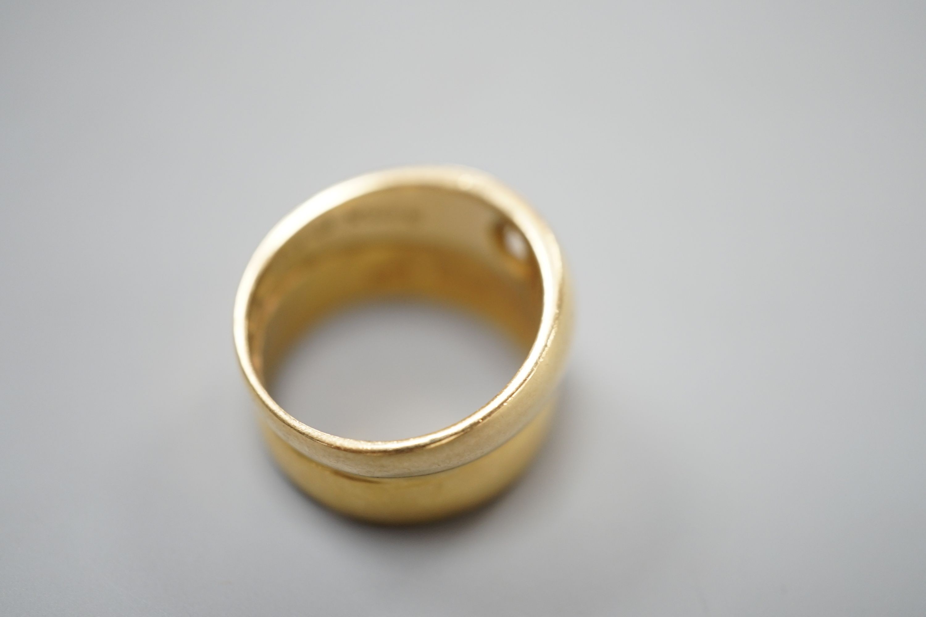 A 22ct gold band, welded to an 18ct gold and diamond set band, size L, gross weight 8.3 grams.